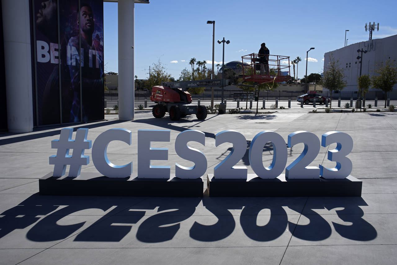 A worker drives a lift during preparations at the Las Vegas Convention Center before the start of t...