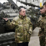 
              Britain's Defence Secretary Ben Wallace, left, speaks with Britain's military officers during his visit to the Tapa Military Camp, in Estonia, Thursday, Jan. 19, 2023. Wallace said his country would send at least three batteries of AS-90 artillery, armoured vehicles, thousands of rounds of ammunition and 600 Brimstone missiles, as well as the squadron of Challenger 2 tanks. (AP Photo/Pavel Golovkin)
            
