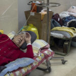 
              Elderly patients rest along a corridor of the emergency ward as they receive intravenous drips in Beijing, Thursday, Jan. 5, 2023. Patients, most of them elderly, are lying on stretchers in hallways and taking oxygen while sitting in wheelchairs as COVID-19 surges in China's capital Beijing. (AP Photo/Andy Wong)
            