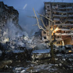 
              Emergency workers clear the rubble after a Russian rocket hit a multistory building leaving many people under debris in Dnipro, Ukraine, Saturday, Jan. 14, 2023. (AP Photo/Roman Chop)
            