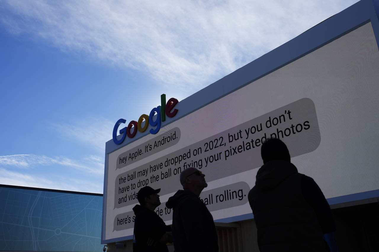 Workers help set up the Google booth at the Las Vegas Convention Center before the start of the CES...