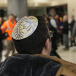
              A man wears a kippah displaying a map of the New York City subways after the inaugural ride of a new Long Island Railroad route into Grand Central Station in New York, Wednesday, Jan. 25, 2023. After years of delays and massive cost overruns, one of the world's most expensive railway projects on Wednesday began shuttling its first passengers between Long Island to a new annex to New York City's iconic Grand Central Terminal. (AP Photo/Seth Wenig)
            
