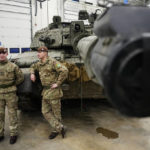
              Britain's military officers stand next to a Challenger 2 tank at the Tapa Military Camp, in Estonia, Thursday, Jan. 19, 2023.  Britain's Defence Minister Wallace said his country would send at least three batteries of AS-90 artillery, armoured vehicles, thousands of rounds of ammunition and 600 Brimstone missiles, as well as the squadron of Challenger 2 tanks. (AP Photo/Pavel Golovkin)
            
