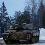 
              Britain's Challenger 2 tank moves at the Tapa Military Camp, in Estonia, Thursday, Jan. 19, 2023. Senior officials from Britain, Poland, the Baltic nations and other European countries met in Estonia on Thursday before the Ramstein gathering. (AP Photo/Pavel Golovkin)
            