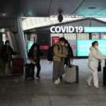 Passengers arriving from China pass by a COVID-19 testing center at the Incheon International Airport In Incheon, South Korea, Tuesday, Jan. 10, 2023. Chinese embassies stopped issuing new visas for South Koreans and Japanese on Tuesday in apparent retaliation for COVID-19 measures recently imposed by those countries on travelers from China. (AP Photo/Ahn Young-joon)