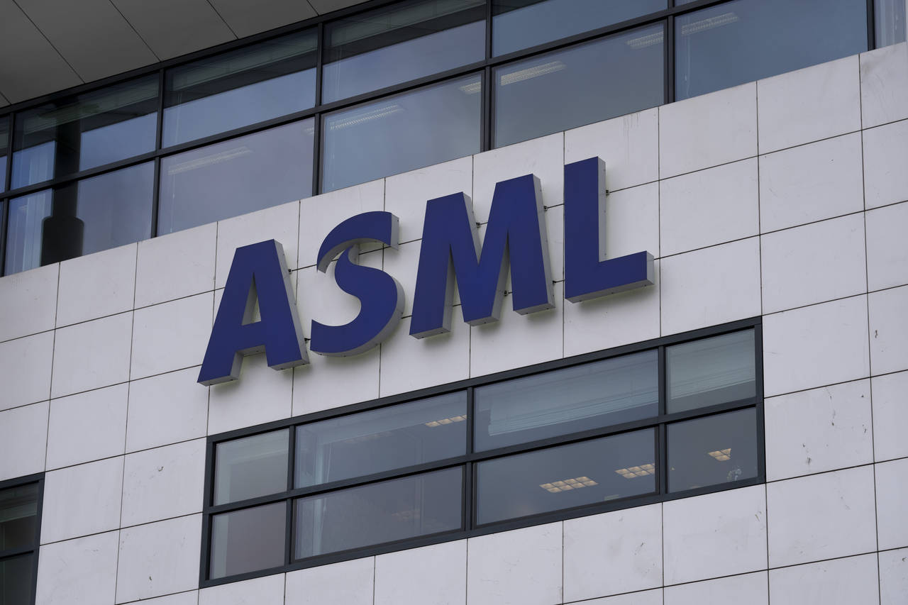FILE - the logo of ASML, a leading maker of semiconductor production equipment, hangs on the head o...