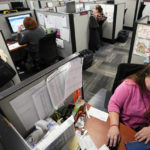 
              FILE - Workers field calls at an intake call screening center for the Allegheny County Children and Youth Services office in Penn Hills, Pa. on Thursday, Feb. 17, 2022. Incidents of potential neglect are reported to Allegheny County's child protection hotline. The reports go through a screening process where an algorithm calculates the child's potential risk and assigns it a score. Social workers then use their discretion to decide whether to investigate those concerns. (AP Photo/Keith Srakocic, File)
            