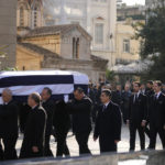 
              CORRECTS THE NAME OF PRINCE ON THE RIGHT Prince Philippos, walking behind coffin left, Prince Pavlos, center, and  Prince Nikolaos, right, sons of former king of Greece Constantine II walk behind their father coffin as they arrive at the Metropolitan cathedral for his funeral in Athens, Monday, Jan. 16, 2023. Constantine died in a hospital late Tuesday at the age of 82 as Greece's monarchy was definitively abolished in a referendum in December 1974. (AP Photo/Petros Giannakouris)
            
