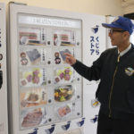 
              CORRECTS THE PHOTOGRAPHER'S NAME TO KWIYEON HA - Konomu Kubo, a spokesperson for Kyodo Senpaku Co. explains how whale meat is being sold from a vending machine at the firm's store, Thursday, Jan. 26, 2023, in Yokohama, Japan. The Japanese whaling operator, after struggling for years to promote its controversial products, has found a new way to cultivate clientele and bolster sales: whale meat vending machines. (AP Photo/Kwiyeon Ha)
            