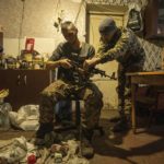 
              Ukrainian servicemen of Karpatska Sich battalion "Diesel", left and "Sten",right, install a scope on a AK-74 rifle near the recently liberated town of Lyman, Ukraine, Sunday, Jan. 8, 2023. (AP Photo/Evgeniy Maloletka)
            