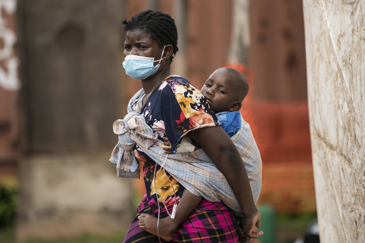 A woman carries her son, who has cholera, at Bwaila Hospital in Lilongwe central Malawi, Wednesday,...