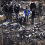 
              French investigators inspect the wreckage of a passenger plane at the crash site, in Pokhara, Nepal, Wednesday, Jan.18, 2023. Nepalese authorities are returning to families the bodies of plane crash victims and are sending the aircraft's data recorder to France for analysis as they try to determine what caused the country's deadliest air accident in 30 years. The flight plummeted into a gorge on Sunday while on approach to the newly opened Pokhara International Airport in the foothills of the Himalayas, killing all 72 aboard.(AP Photo/Yunish Gurung)
            
