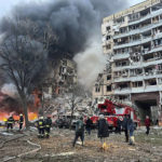 
              In this photo released by the Ukrainian Presidential Press Office, smoke rises after a Russian rocket hit a multistory building leaving many people under debris in Dnipro, Ukraine, Saturday, Jan. 14, 2023. (Ukrainian Presidential Press Office via AP)
            