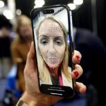 
              A booth worker demonstrates L'Oreal's smart brow applicator that uses augmented reality to help print eyebrows on the face during CES Unveiled, before the CES tech show, Tuesday, Jan. 3, 2023, in Las Vegas. (AP Photo/Rick Bowmer)
            