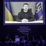 
              President Volodymyr Zelenskyy of Ukraine talks from a video screen to participants at the World Economic Forum in Davos, Switzerland on Wednesday, Jan. 18, 2023. The annual meeting of the World Economic Forum is taking place in Davos from Jan. 16 until Jan. 20, 2023. (AP Photo/Markus Schreiber)
            