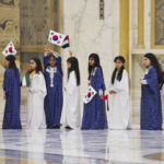 
              Emirati school girls prepare to greet South Korean President Yoon Suk Yeol at Qasar Al Watan in Abu Dhabi, United Arab Emirates, Sunday, Jan. 15, 2023. South Korean President Yoon Suk Yeol received an honor guard welcome Sunday on a trip to the United Arab Emirates, where Seoul hopes to expand its military sales while finishing its construction of the Arabian Peninsula's first nuclear power plant. (AP Photo/Jon Gambrell)
            