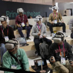 
              Attendees wear VR headsets while previewing the Caliverse Hyper-Realistic Metaverse experience at the Lotte booth during the CES tech show Friday, Jan. 6, 2023, in Las Vegas. (AP Photo/John Locher)
            
