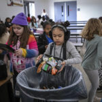 
              Students dispose of their unfinished food at the end of lunch break at Yavapai Elementary School in Scottsdale, Ariz., Dec. 12, 2022. Funding, labor and supply shortages have limited the school district's ability to cook and serve fresh food, making it more reliant on prepackaged, ready-to-eat items. (AP Photo/Alberto Mariani)
            