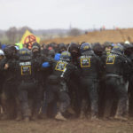 
              Police officers push back demonstrators on the edge of the opencast lignite mine Garzweiler at the village Luetzerath near Erkelenz, Germany, Saturday, Jan. 14, 2023. ( Oliver Berg/dpa via AP)
            