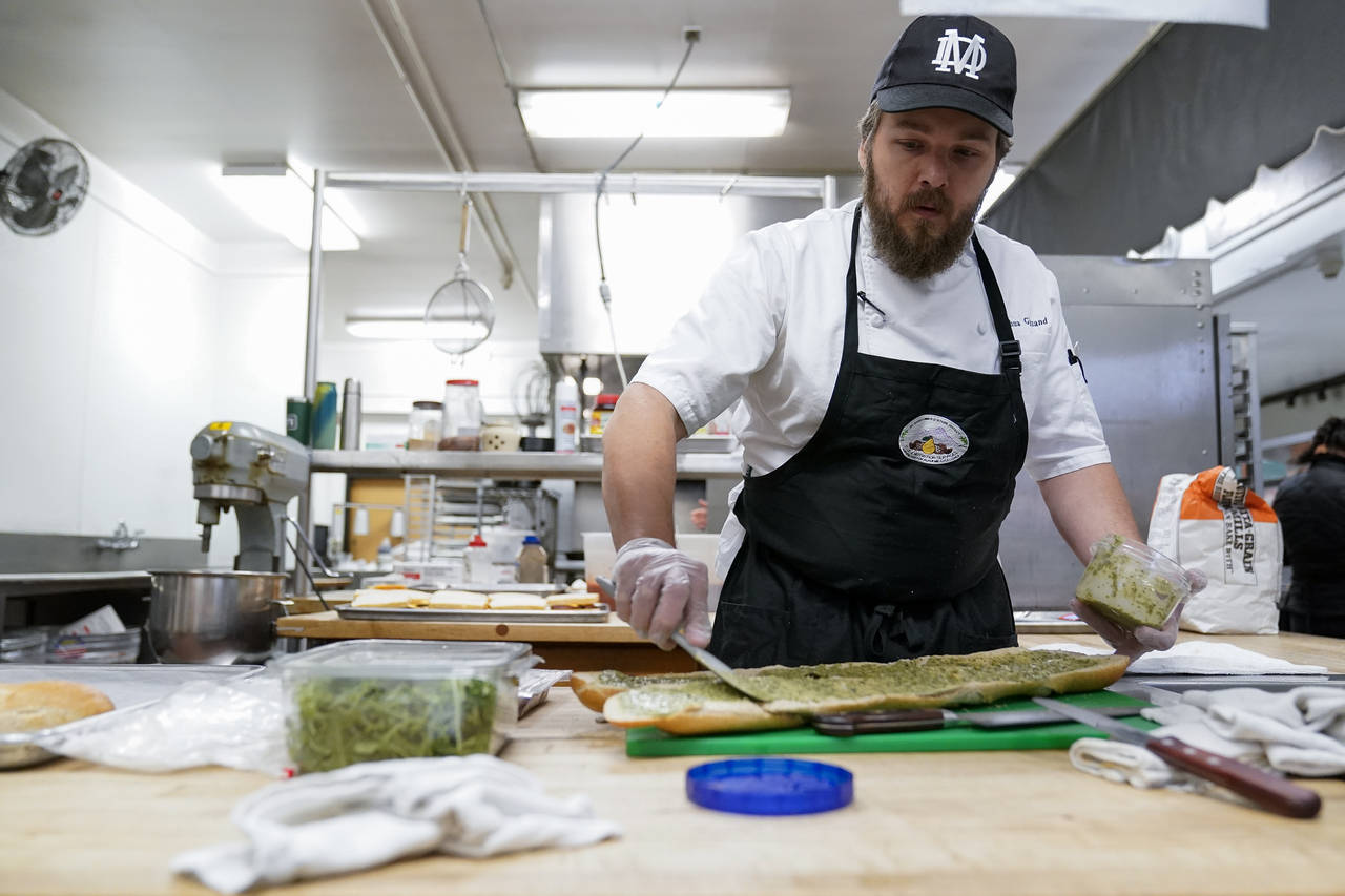 Chef Josh Gjersand prepares a sandwich for Mount Diablo High School students to try during a taste ...