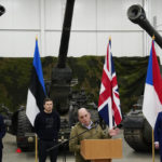 
              Britain's Defence Secretary Ben Wallace, centre, speaks to the media during his visit to the Tapa Military Camp, in Estonia, Thursday, Jan. 19, 2023. Wallace said his country would send at least three batteries of AS-90 artillery, armoured vehicles, thousands of rounds of ammunition and 600 Brimstone missiles, as well as the squadron of Challenger 2 tanks. (AP Photo/Pavel Golovkin)
            