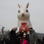 
              A family member takes a selfie in front of a giant rabbit installation to celebrate the Year of the Rabbit for 2023 in the Chinese zodiac at Gwanghwamun Square in Seoul, South Korea, Sunday, Jan. 22, 2023. (AP Photo/Ahn Young-joon)
            