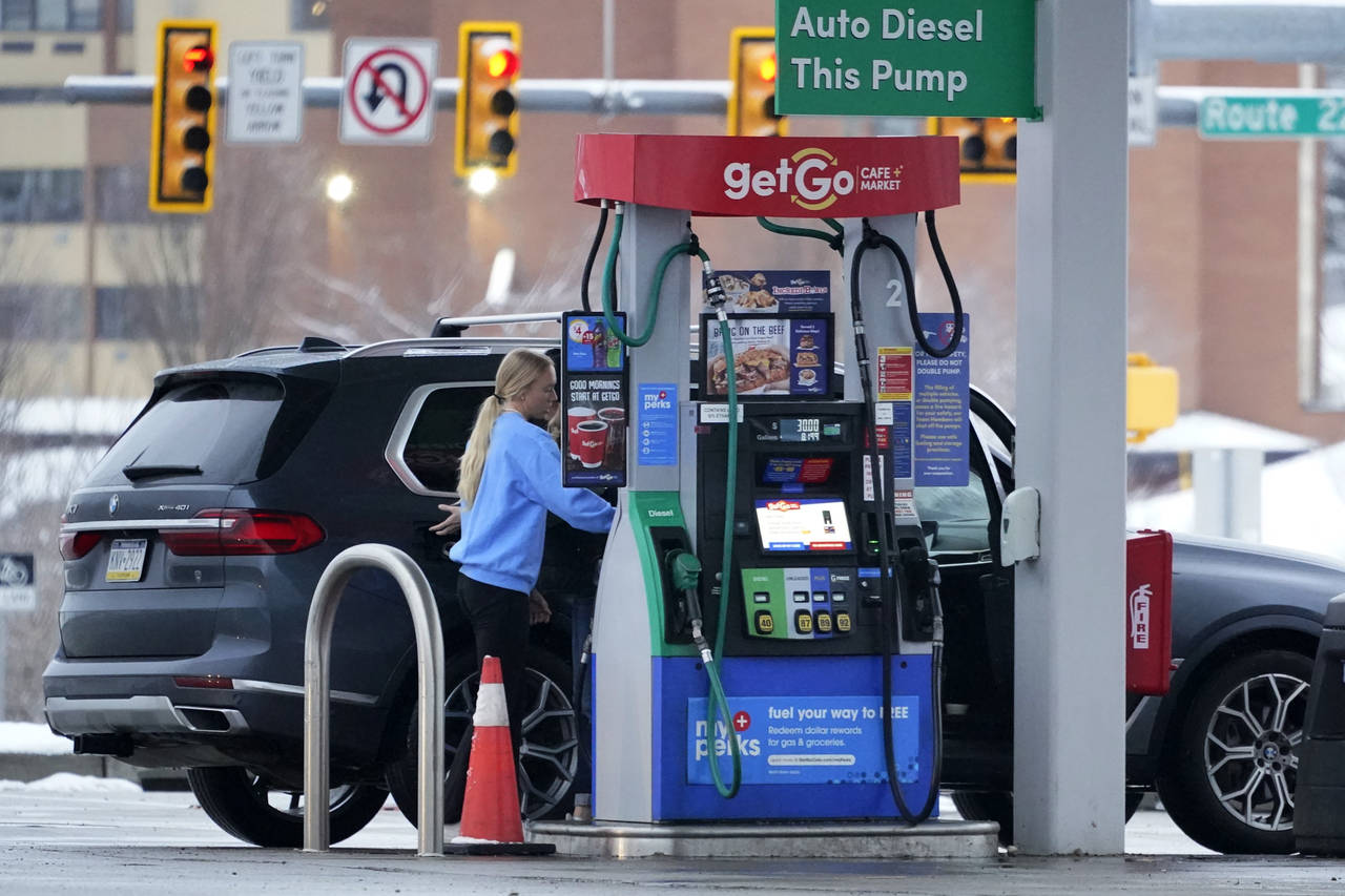 A woman pumps gas at a GetGo Mini Mart in Valencia, Pa., on Monday, Jan. 23, 2023. On Tuesday, the ...