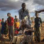 
              FILE - Displaced people who have arrived at a camp wait for plot allocation on the outskirts of Dollow, Somalia, on Sept. 19, 2022. Somalia is in the midst of the worst drought anyone there can remember. The head of the Nobel Peace Prize-winning World Food Program, on Tuesday, Jan. 17, 2023, says support from donors like the United States and Germany have allowed it to postpone — though not entirely avert — famine in Somalia(AP Photo/Jerome Delay, File)
            