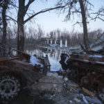 
              A destroyed bridge across Siverskyi-Donets river in the recently retaken village of Bogorodychne, Ukraine, Saturday, Jan. 7, 2022. (AP Photo/Evgeniy Maloletka)
            