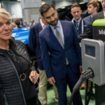 
              Energy Secretary Jennifer Granholm, left, and and White House national climate adviser Ali Zaidi, center, look at a charging station from blink during a visit to the Washington Auto Show in Washington, Wednesday, Jan. 25, 2023. (AP Photo/Andrew Harnik)
            