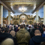 
              People attend the Christmas service in the Cathedral in Kherson, Ukraine, Saturday, Jan. 7, 2023. (AP Photo/Libkos)
            
