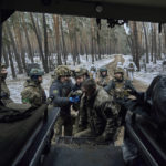 
              Military medics help a wounded soldier into an evacuation vehicle near Kremenna in the Luhansk region, Ukraine, Monday, Jan. 16, 2023. (AP Photo/LIBKOS)
            