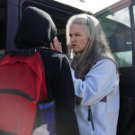 
              Jessie Blanchard talks with a participant near her jeep, outside of a motel where she hands out goods like Naloxone, tourniquet, needles, food, and other materials to help the community, on Monday, Jan. 23, 2023, in Albany, Ga. Blanchard started small nearly five years ago, just trying to get enough of the rescue drug naloxone that reverses opioid overdoses to keep her daughter from dying from an overdose. (AP Photo/Brynn Anderson)
            