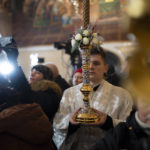 
              A priest holds a candle during an Orthodox Christmas service inside the nearly 1,000-year-old Pechersk Lavra Cathedral of Kyiv, Ukraine, Saturday, Jan. 7, 2023. Hundreds of Ukrainians heard the Orthodox Christmas service in the Ukrainian language for the first time at Kyiv’s 1,000-year-old Lavra Cathedral on Orthodox Christmas Day, a demonstration of independence from the Russian orthodox church. (AP Photo/Roman Hrytsyna)
            