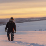 
              FILE - Reindeer herder Niila Inga from the Laevas Sami community walks across the snow as the sun sets on Longastunturi mountain near Kiruna, Sweden, on Nov. 27, 2019. A Swedish government-owned iron ore mining company says it has identified “significant deposits” of rare earth elements in Arctic Sweden that are essential for the manufacture of electric vehicles and wind turbines. LKAB's CEO said the quantity of rare earth metals exceeds 1 million tons and is the largest known deposit of its kind in Europe. Sweden's Energy and Business Minister said "the EU’s self-sufficiency and independence from Russia and China will begin in the mine.” (AP Photo/Malin Moberg)
            