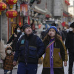 
              Visitors wearing face masks tour a pedestrian shopping street at Qianmen walking street in Beijing, Tuesday, Jan. 3, 2023. As the virus continues to rip through China, global organizations and governments have called on the country start sharing data while others have criticized its current numbers as meaningless. (AP Photo/Andy Wong)
            