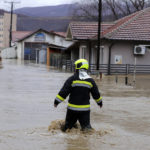 
              A firefighter walks through a flooded street in northern Serb-dominated part of ethnically divided town of Mitrovica, Kosovo, Thursday, Jan. 19, 2023. Heavy rainfall this week across the Balkans has caused rivers to rise dangerously in Serbia, Bosnia, Kosovo and Montenegro, flooding some areas and threatening flood defenses elsewhere. (AP Photo/Bojan Slavkovic)
            