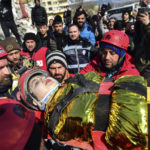 
              Rescuers carry Zeynep Polat, pulled out from a collapsed building days after the earthquake, in Kahramanmaras, southern Turkey, Thursday, Feb. 9, 2023. Thinly stretched rescue teams worked through the night in Turkey and Syria, pulling more bodies from the rubble of thousands of buildings toppled by a catastrophic earthquake. (Ismail Coskun/IHA via AP)
            