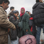 
              Syrians wait to cross into Syria from Turkey at the Cilvegozu border gate, near the town of Antakya, southeastern Turkey, Tuesday, Feb. 21, 2023. The death toll in Turkey and Syria rose to eight in a new and powerful earthquake that struck two weeks after a devastating temblor killed nearly 45,000 people, authorities and media said Tuesday. (AP Photo/Unal Cam)
            