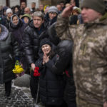 
              Anastasia, center, cries as soldiers carry the coffin of her brother Oleg Kunynets, a Ukrainian military servicemen who were killed in the east of the country, during his funeral in Lviv, Ukraine, Tuesday, Feb 7, 2023. (AP Photo/Emilio Morenatti)
            