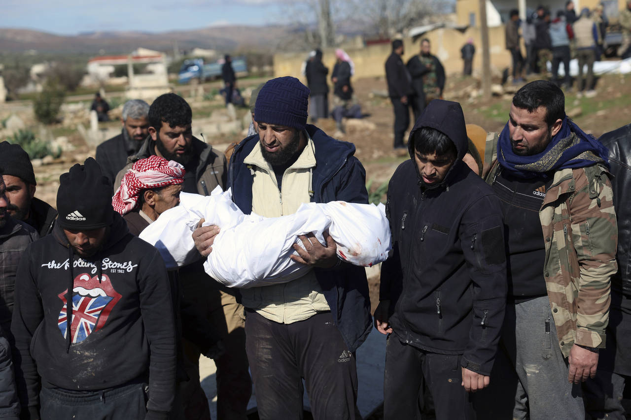 Mourners bury family members who died in a devastating earthquake that rocked Syria and Turkey at a...