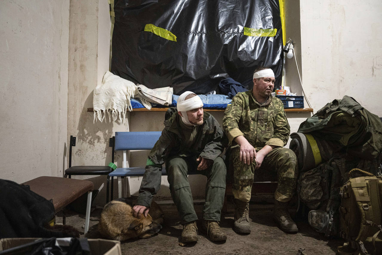 Ukrainian servicemen who were wounded at the battlefield wait to leave the field hospital near Bakh...