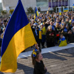 
              A girls holds the Ukraine flag as Ukrainians and their supporters gather to mark the one-year anniversary of Russia's invasion of Ukraine in Tel Aviv, Israel, Friday, Feb. 24, 2023. (AP Photo/Ariel Schalit)
            