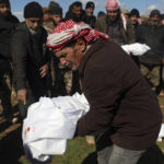 
              Mourners bury family members who died in a devastating earthquake that rocked Syria and Turkey at a cemetery in the town of Jinderis, Aleppo province, Syria, Tuesday, Feb. 7, 2023.  A newborn girl was found buried under debris with her umbilical cord still connected to her mother, Afraa Abu Hadiya, who was found dead, according to relatives and a doctor.  The baby was the only member of her family to survive from the building collapse Monday in  Jinderis, next to the Turkish border, Ramadan Sleiman, a relative, told The Associated Press.  (AP Photo/Ghaith Alsayed)
            