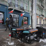 
              People pass by working generators during a power outage in Kyiv, Ukraine, Monday, Feb. 6, 2023. Russia has been bombing Ukrainian power grids for months, which caused rolling and emergency blackouts across the country. (AP Photo/Efrem Lukatsky)
            