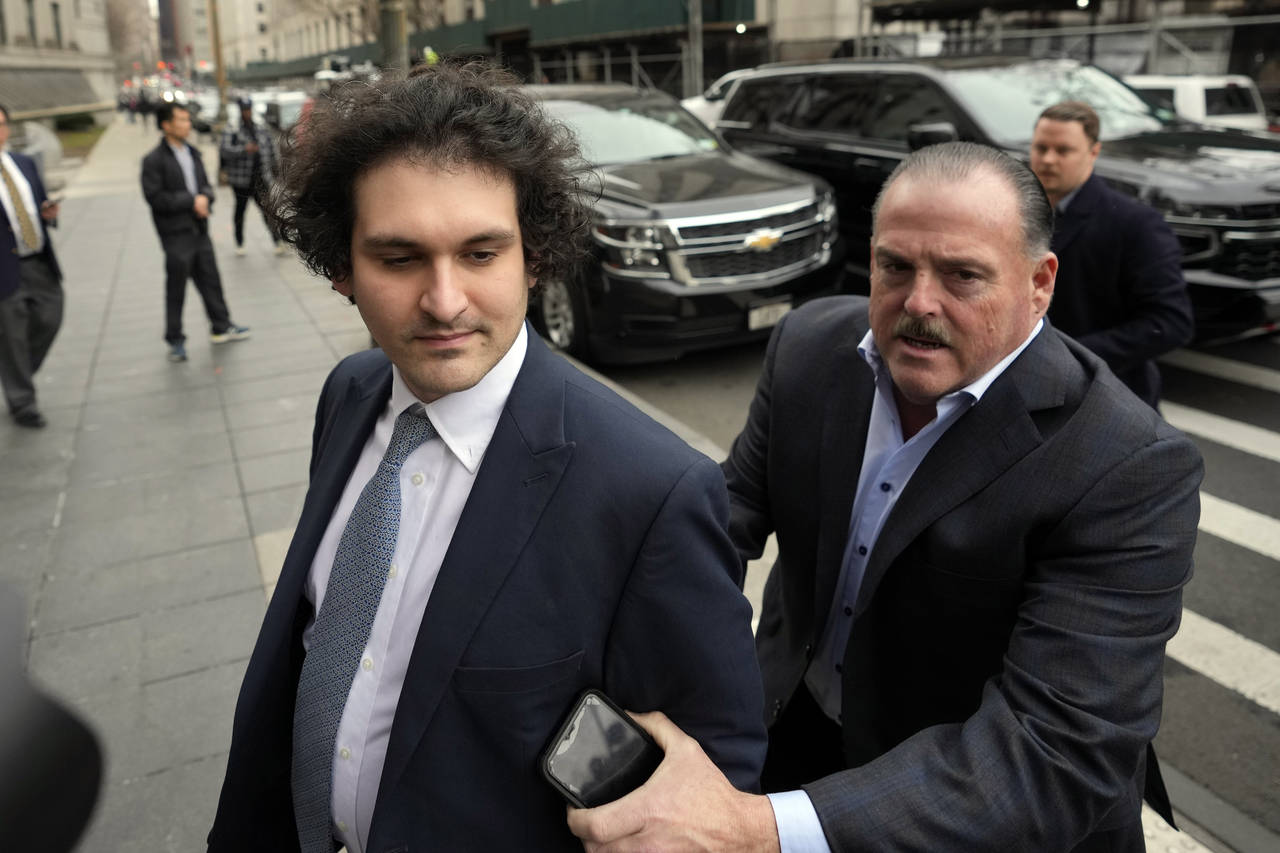 FTX founder Sam Bankman-Fried, left, arrives at Manhattan federal court, Thursday, Feb.16, 2023, in...