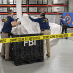 
              FILE - In this image provided by the FBI, FBI special agents assigned to the evidence response team process material recovered from the high altitude balloon recovered off the coast of South Carolina, Feb. 9, 2023, at the FBI laboratory in Quantico, Va. The United States on Friday, Feb. 10 blacklisted six Chinese entities it said were linked to Beijing's aerospace programs as part of its retaliation over an alleged Chinese spy balloon that traversed the country's airspace. (FBI via AP, File)
            