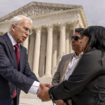 
              Attorney Eric Schnapper, left, talks with Beatriz Gonzalez, right, the mother of 23-year-old Nohemi Gonzalez, a student killed in the Paris terrorist attacks, and stepfather Jose Hernandez, second from right, in front of the Supreme Court, Wednesday, Feb. 22, 2023 in Washington, after the Supreme Court heard oral arguments in Twitter v. Taamneh today which will decide whether social media companies can be sued for aiding and abetting a specific act of international terrorism when the platforms have hosted user content that expresses general support for the group behind the violence without referring to the specific terrorist act in question. (AP Photo/Andrew Harnik)
            