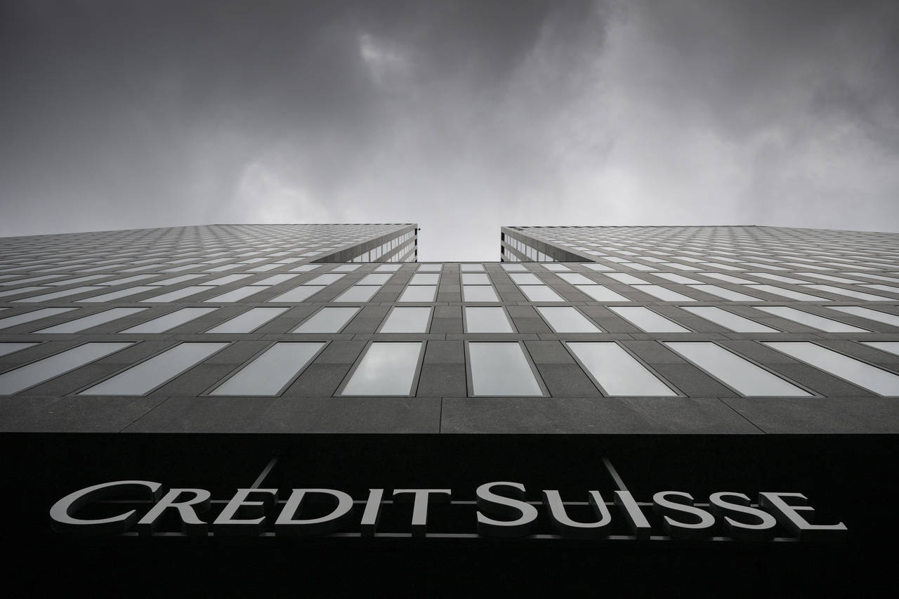 FILE - Grey clouds cover the sky over a building of the Credit Suisse bank in Zurich, Switzerland, ...