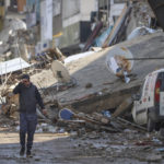 
              A man walks past debris from destroyed buildings in Antakya, southeastern Turkey, Tuesday, Feb. 21, 2023. The death toll in Turkey and Syria rose to eight in a new and powerful earthquake that struck two weeks after a devastating temblor killed nearly 45,000 people, authorities and media said Tuesday. (AP Photo/Unal Cam)
            